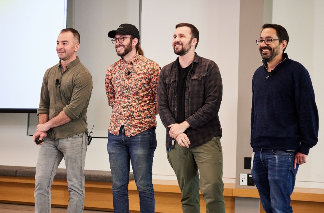 Four members of Square's developer platform leadership standing together in front of a projection screen in a conference room